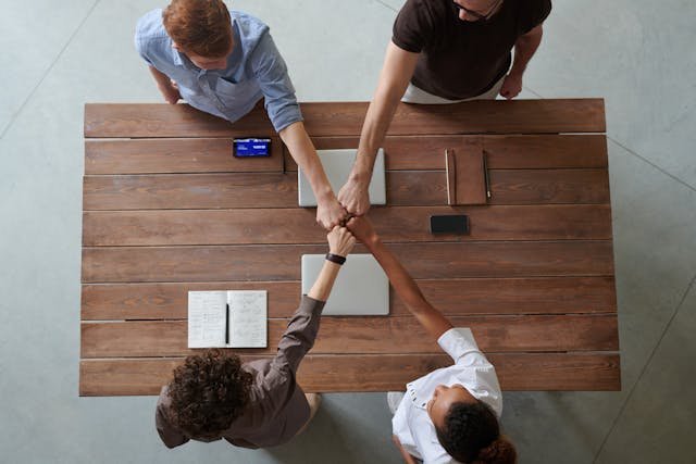 Photo Of People Doing Fist Bump. Photo by fauxels from pexels